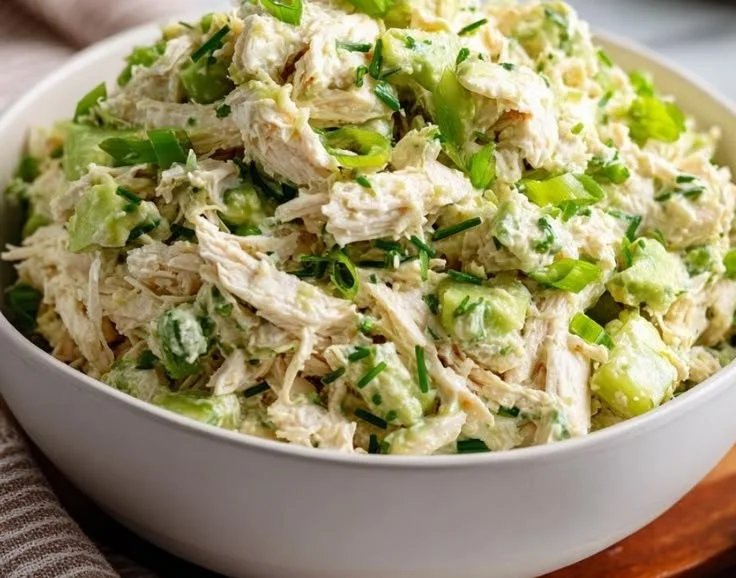 Avocado lime chicken salad bowl with fresh ingredients and vibrant colors.