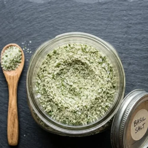 Basil salt in a decorative bowl, highlighting its rich color and texture.