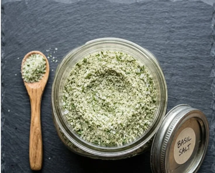 Basil salt in a decorative bowl, highlighting its rich color and texture.