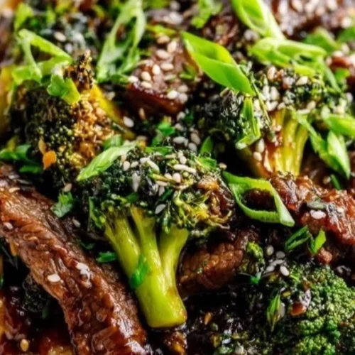 Delicious beef and broccoli stir-fry served with rice on a plate.