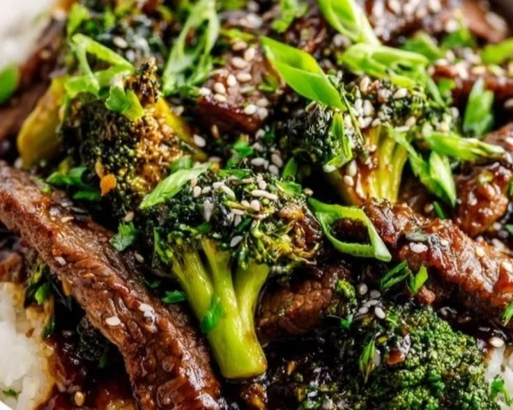Delicious beef and broccoli stir-fry served with rice on a plate.