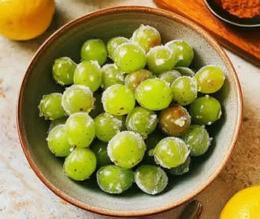 Delicious frozen Tajin grapes served in a bowl, perfect for a refreshing snack.