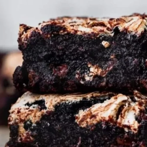 Fudgy marshmallow brownies topped with gooey marshmallows and chocolate drizzle