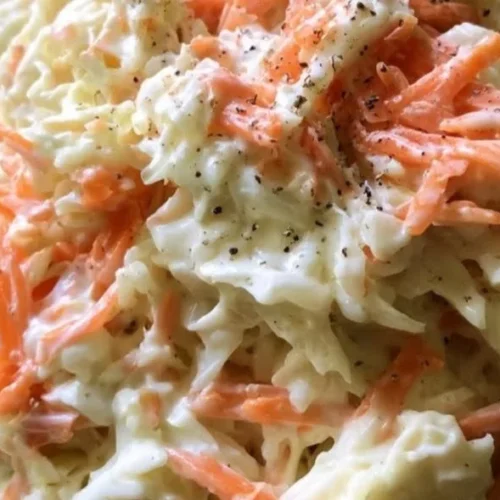 Bowl of homemade coleslaw with fresh cabbage and carrots