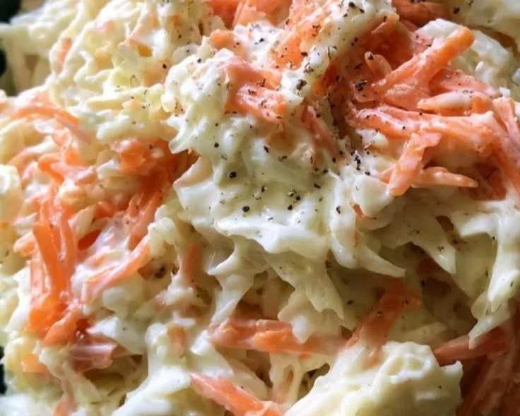 Bowl of homemade coleslaw with fresh cabbage and carrots