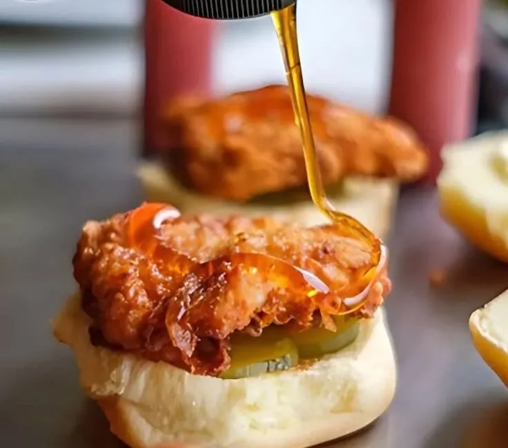 Hot Honey Chicken Slider Sandwich with toppings served on a platter