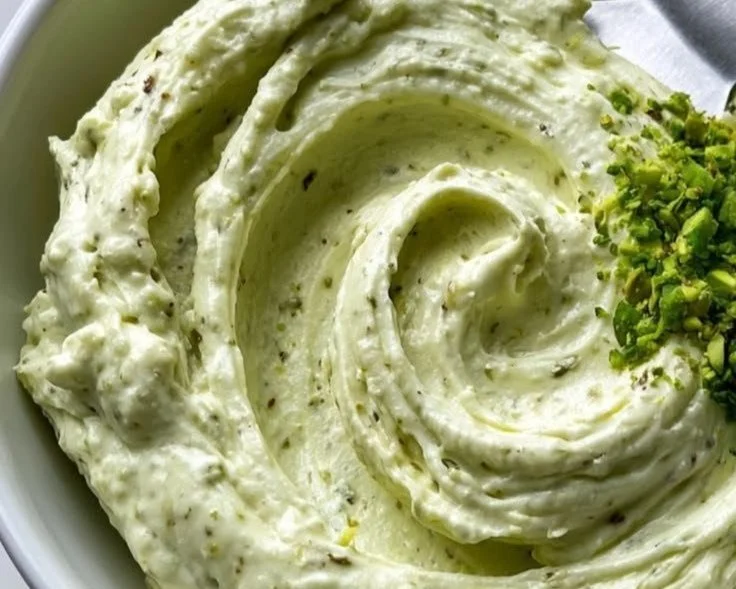 Pistachio Mascarpone Frosting in a bowl with a spatula