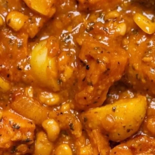 Bowl of robust vegan sweet potato stew with fresh herbs and spices