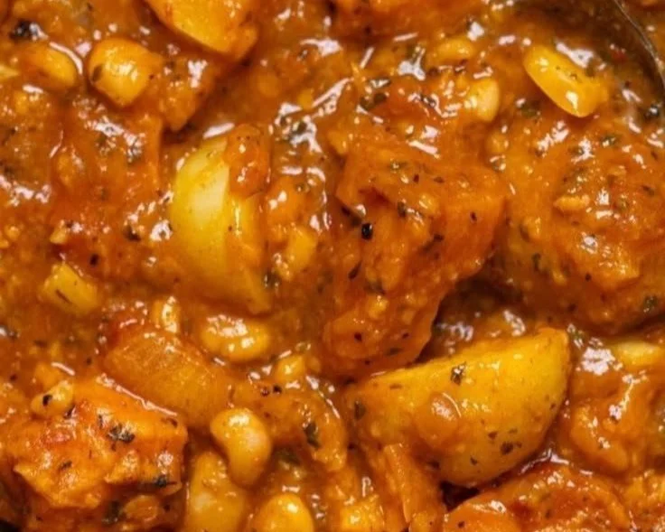 Bowl of robust vegan sweet potato stew with fresh herbs and spices
