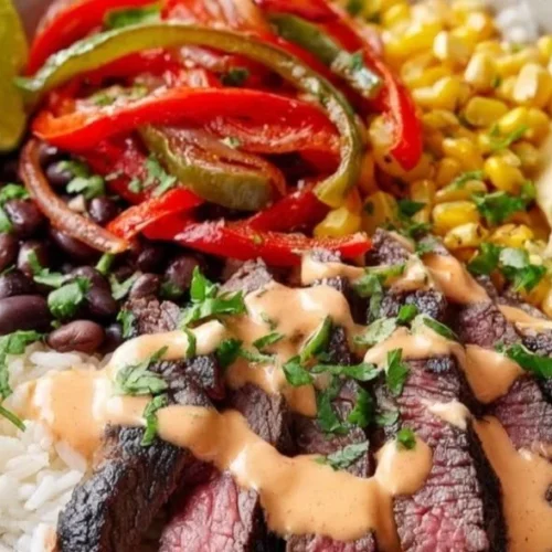 Delicious and colorful steak fajita bowl with grilled vegetables and toppings