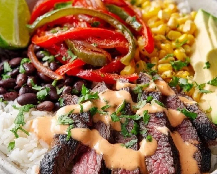 Delicious and colorful steak fajita bowl with grilled vegetables and toppings