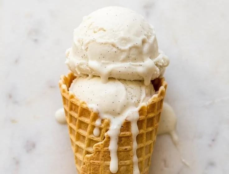 Creamy vegan vanilla ice cream served in a bowl with a sprinkle of nuts