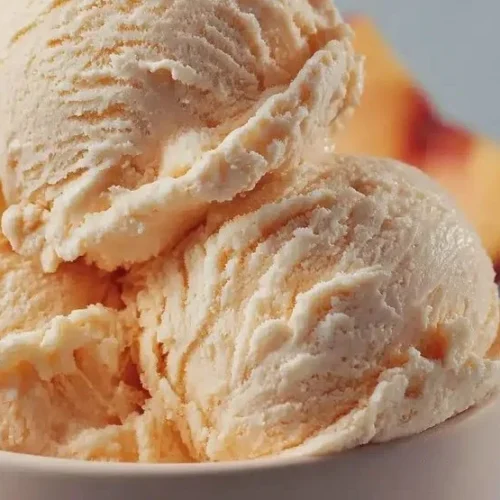 Bowl of homemade peach ice cream made with 3 simple ingredients