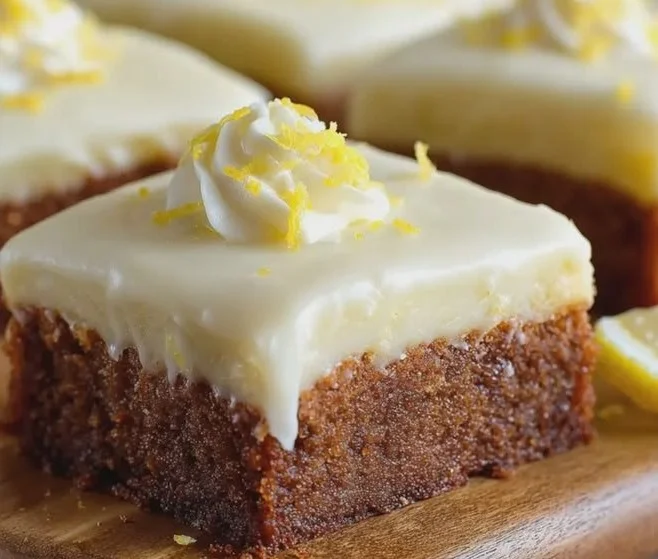Frosted lemon brownies arranged on a plate, topped with zesty lemon frosting.