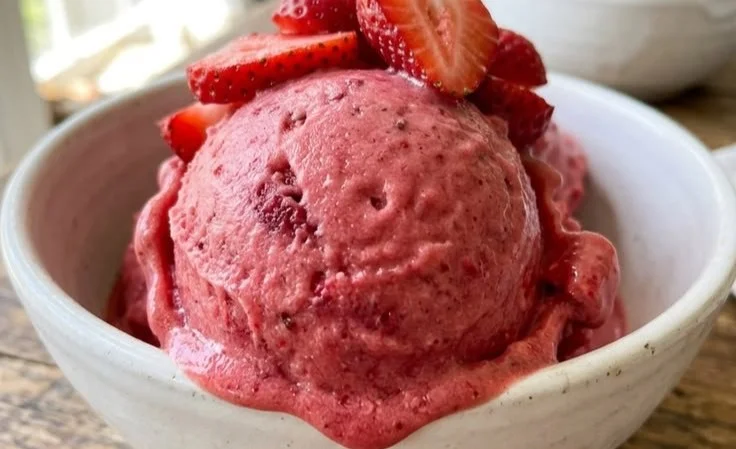 Delicious frozen strawberry treat served in a bowl topped with fresh strawberries